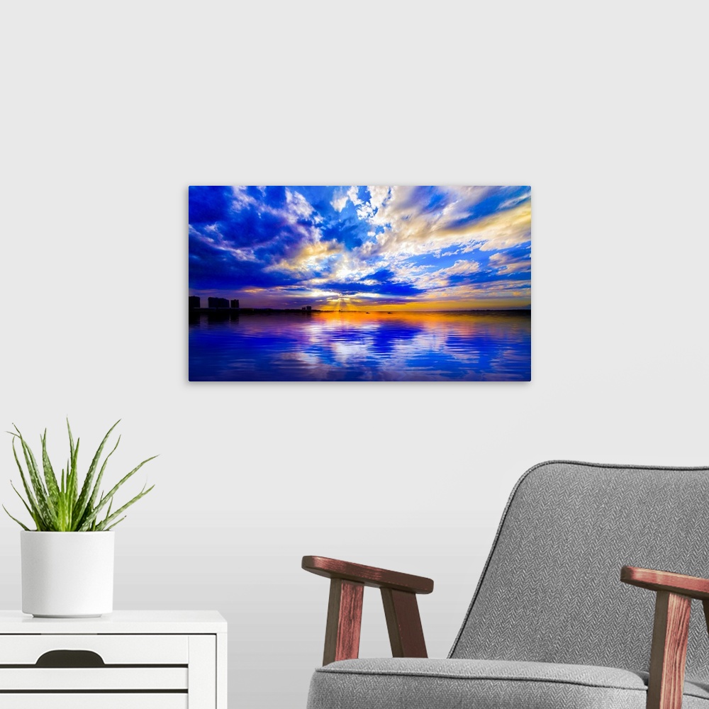 A modern room featuring The sunset reflected in this blue and white seascape during sunset.