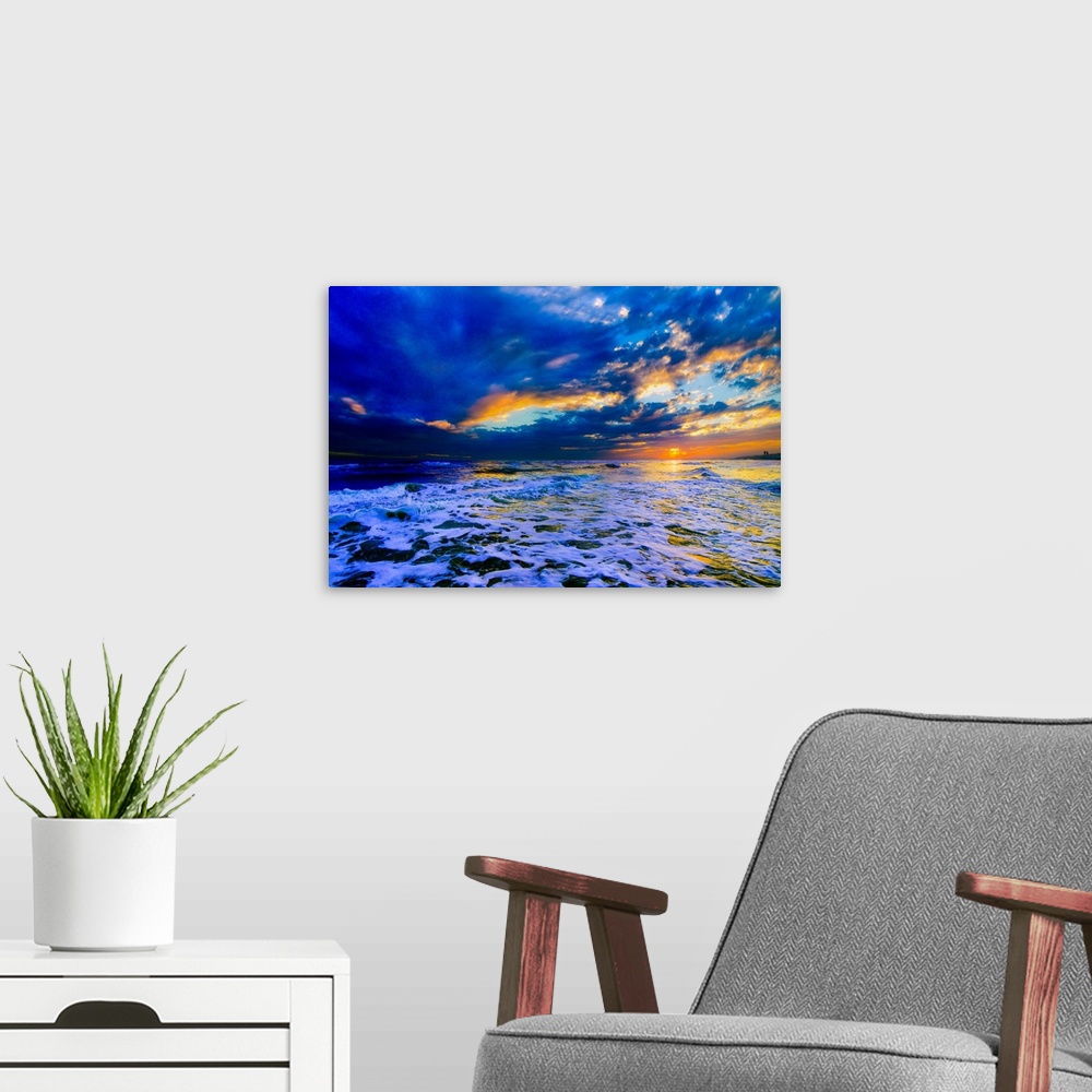 A modern room featuring A beautiful blue beach sunset in this landscape seascape photo. An art print featuring a blue sea...