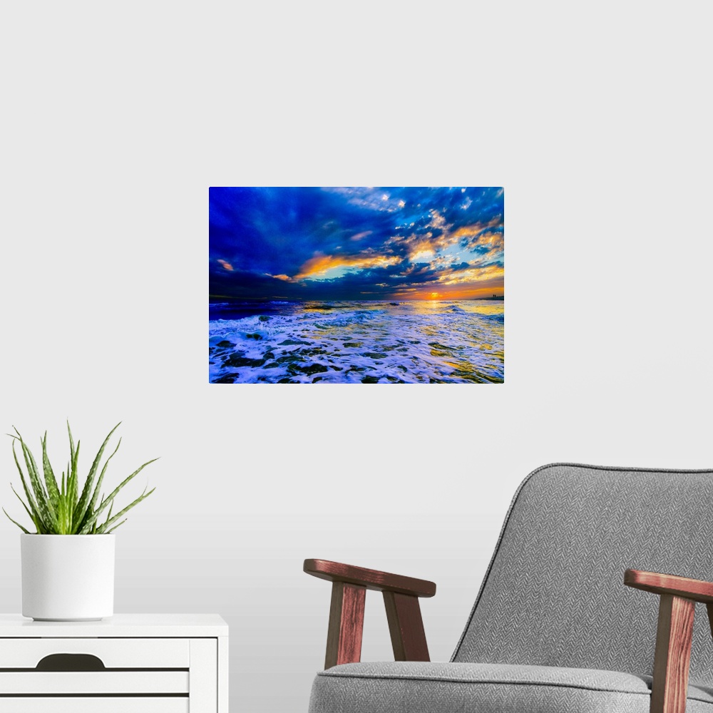 A modern room featuring A beautiful blue beach sunset in this landscape seascape photo. An art print featuring a blue sea...