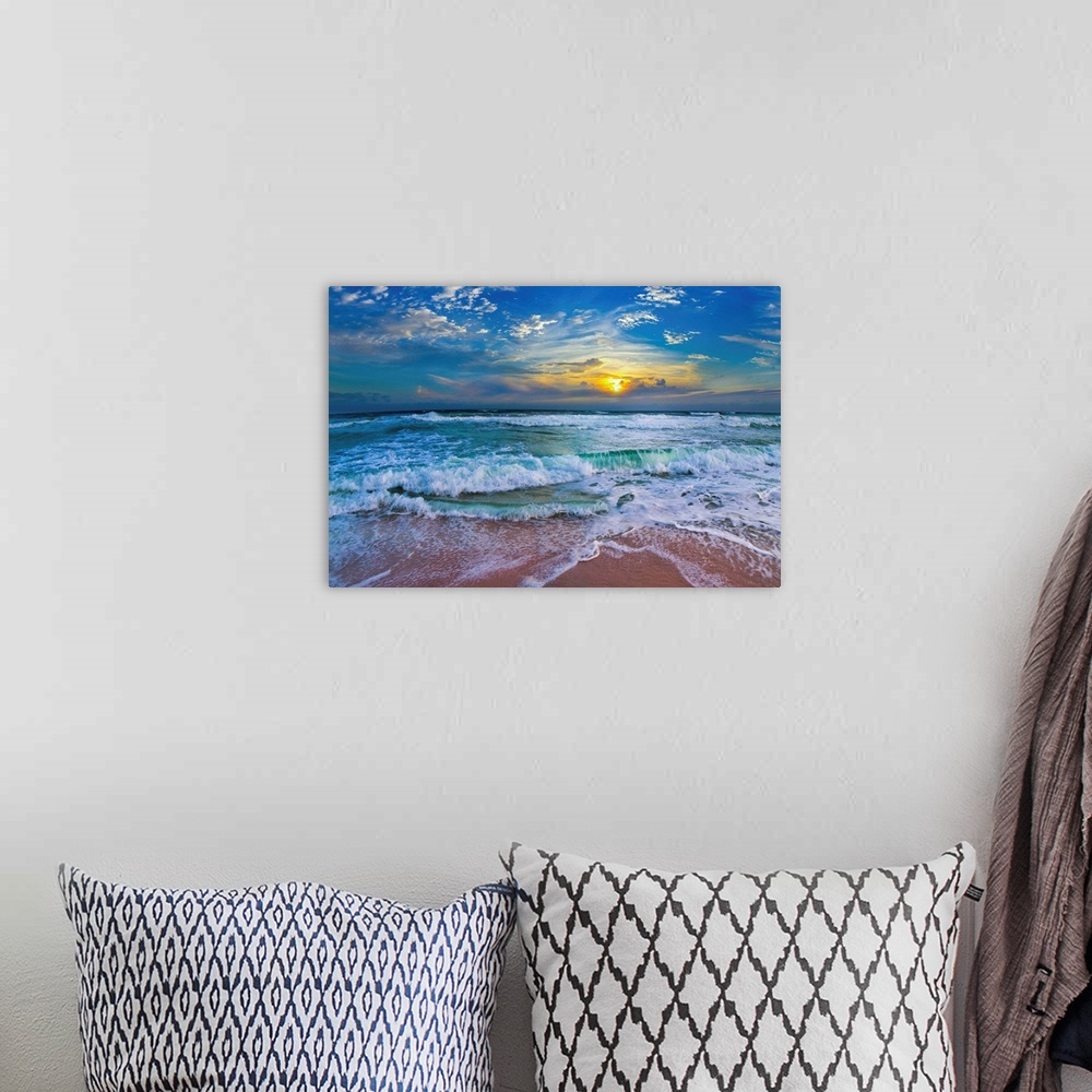 A bohemian room featuring A glimpse of a yellow sunset within a cold blue sunset. Blue waves hit a tropical sea shore.
