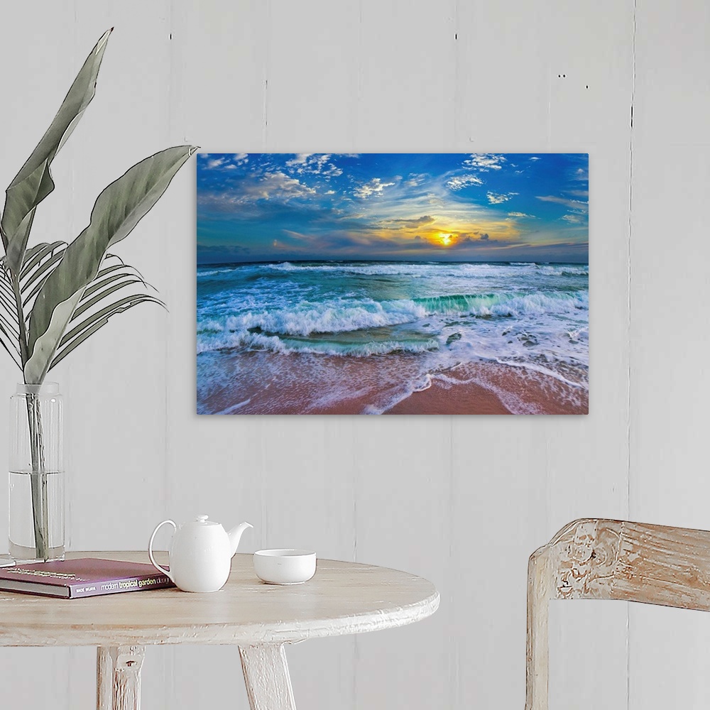 A farmhouse room featuring A glimpse of a yellow sunset within a cold blue sunset. Blue waves hit a tropical sea shore.