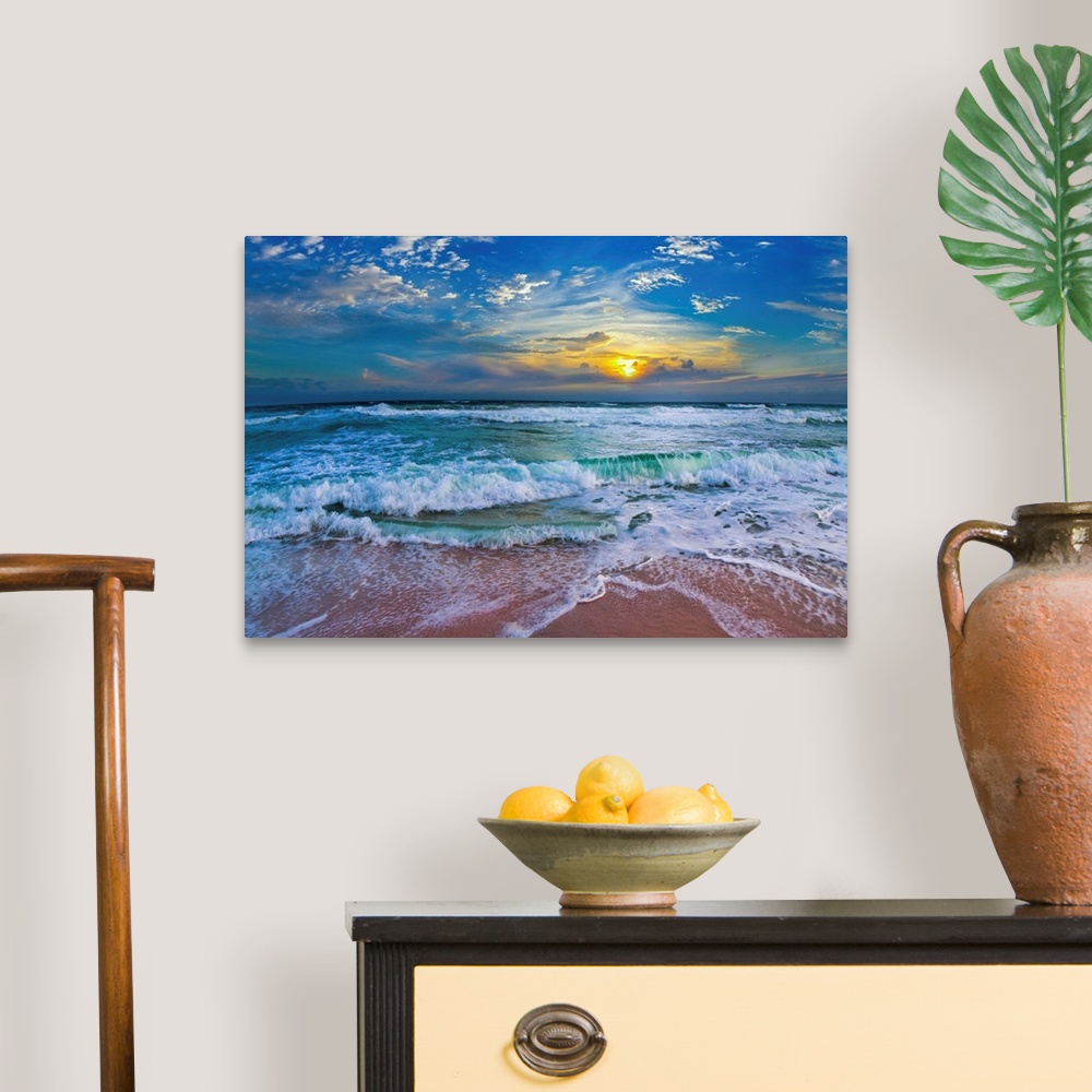 A traditional room featuring A glimpse of a yellow sunset within a cold blue sunset. Blue waves hit a tropical sea shore.