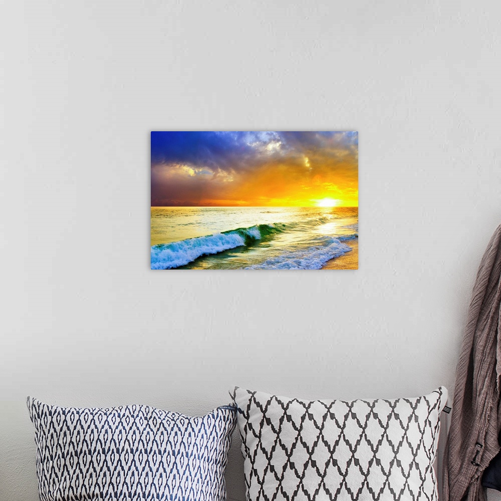 A bohemian room featuring Waves breaking from an emerald sea beneath an orange and blue ocean sunset with green sea surf.