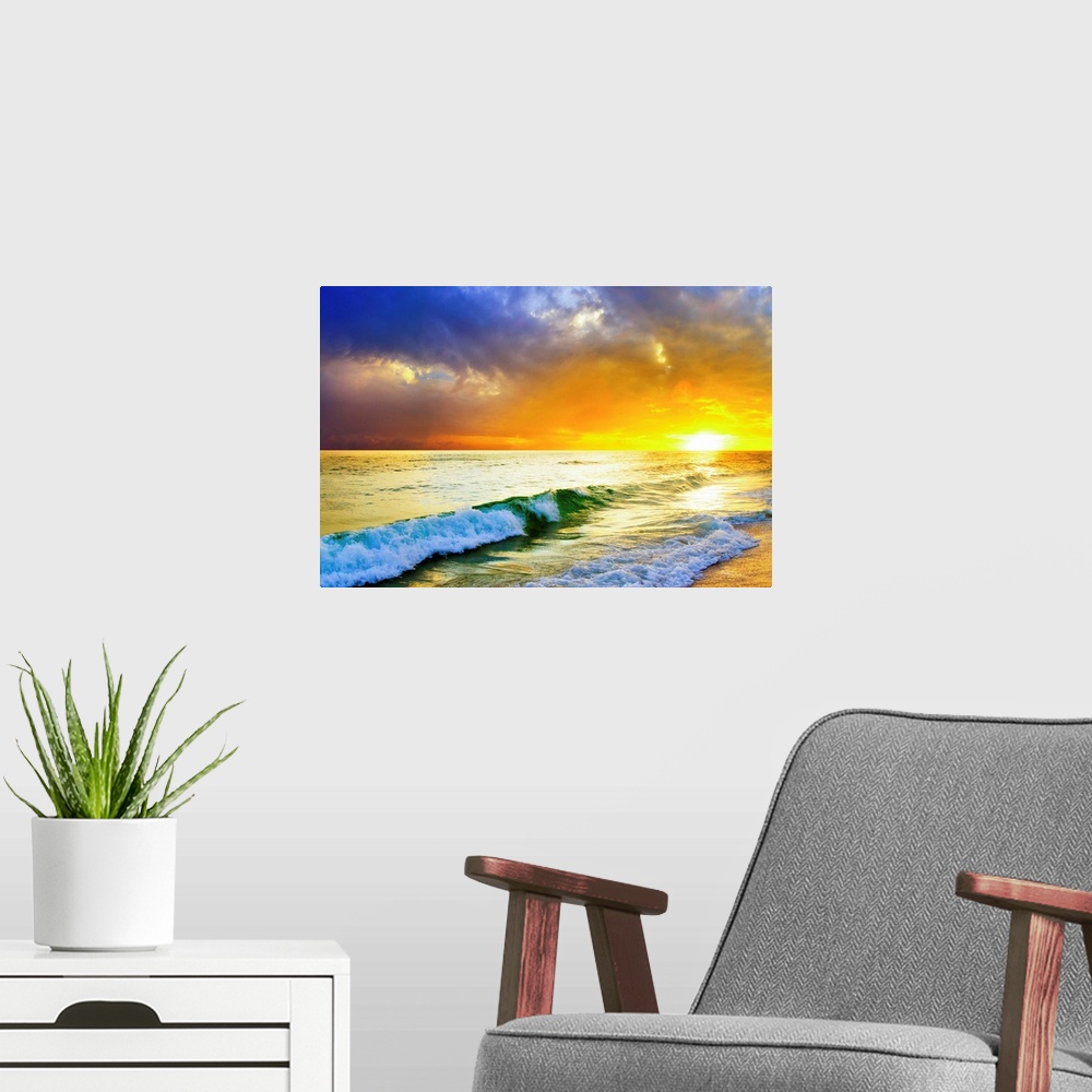 A modern room featuring Waves breaking from an emerald sea beneath an orange and blue ocean sunset with green sea surf.