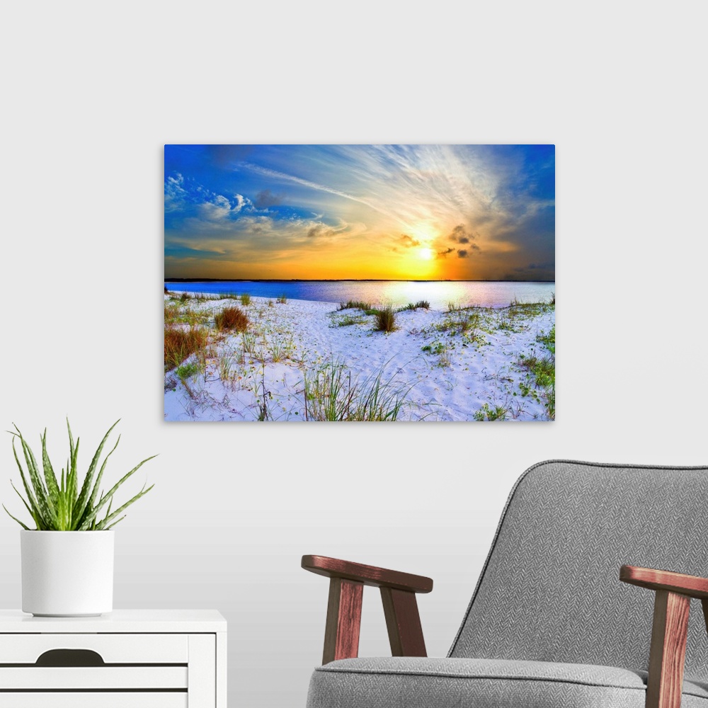 A modern room featuring An orange sunset with sweeping clouds over a white sandy beach landscape. Landscape taken near Na...