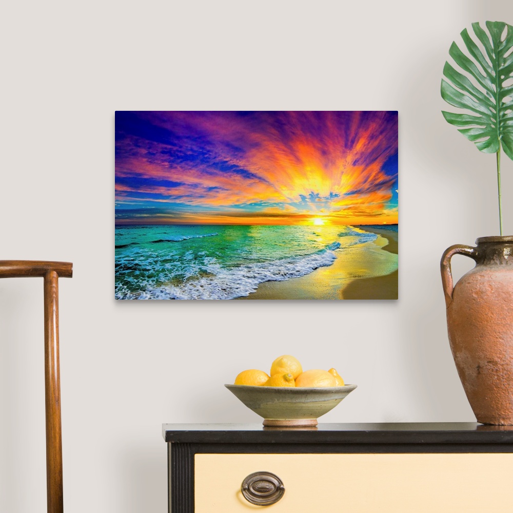 A traditional room featuring A landscape of a colorful ocean sunset in this green sea photo. An art print featuring waves on t...