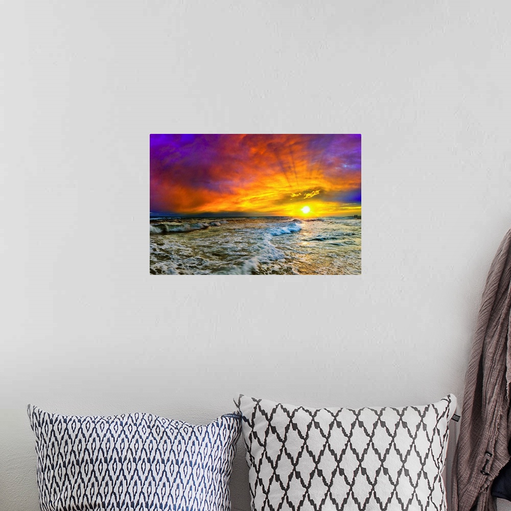 A bohemian room featuring A seascape sunset with fiery red clouds at a beach in Destin, Florida.