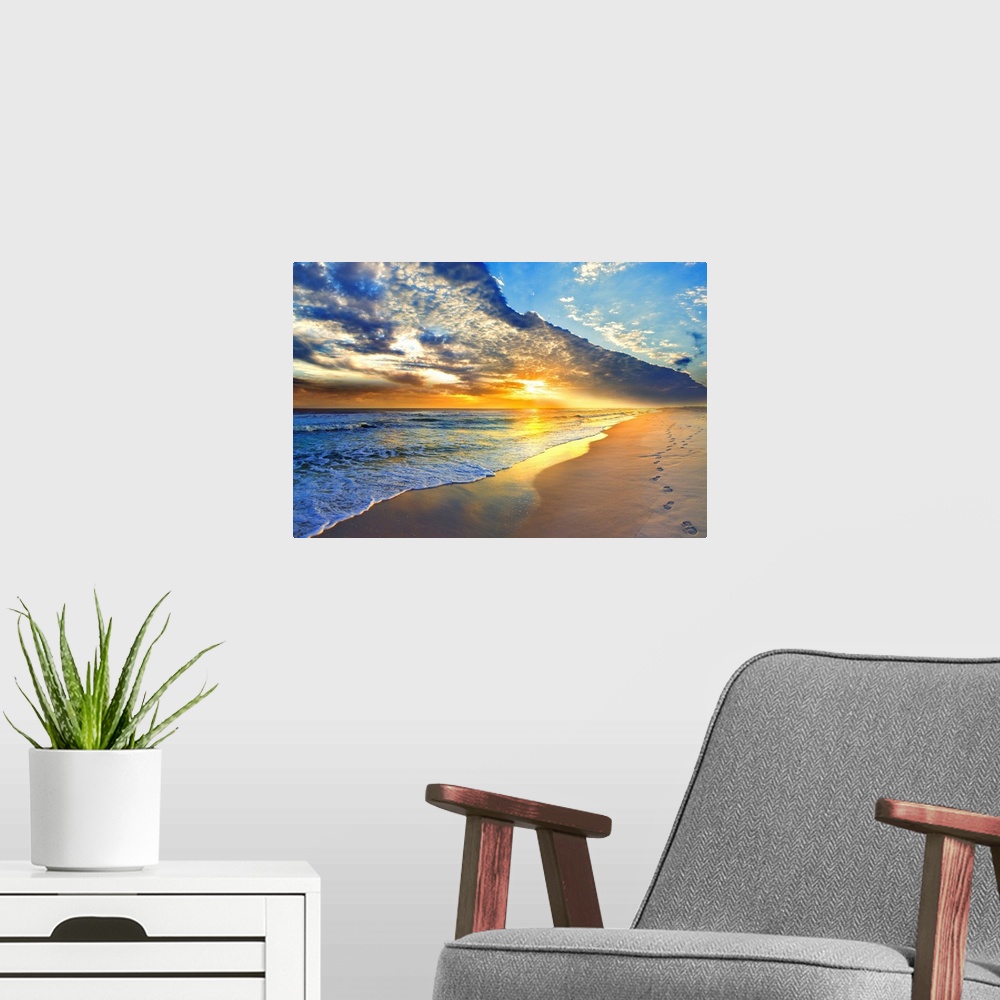 A modern room featuring Bright golden sunset casts light onto the beach and blue seascape below. Landscape taken on Navar...