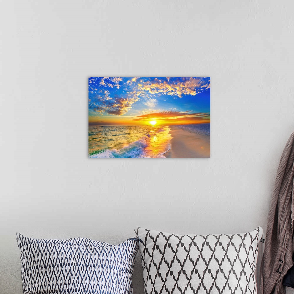 A bohemian room featuring Golden soaked waves on the beach under a blue sky and beautiful sunset.