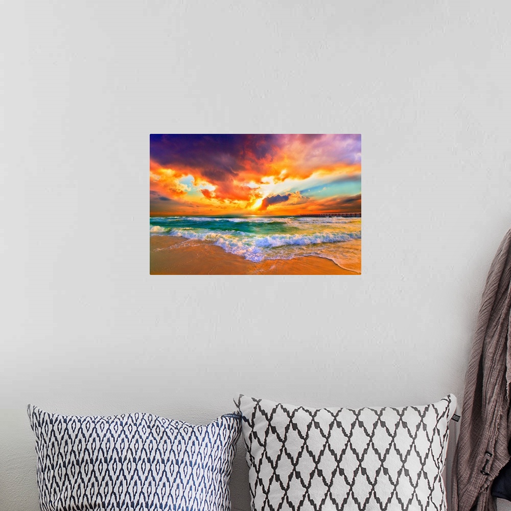 A bohemian room featuring Landscape photography featuring a bright red sunset. Waves crash together in the green sea.
