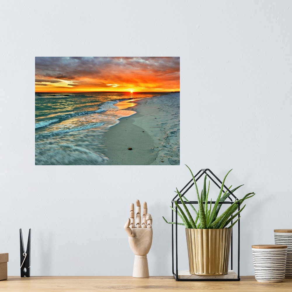 A bohemian room featuring Emerald waves flow over the shore in a soft white foam. Dark yellow and red sunset on the beach. ...