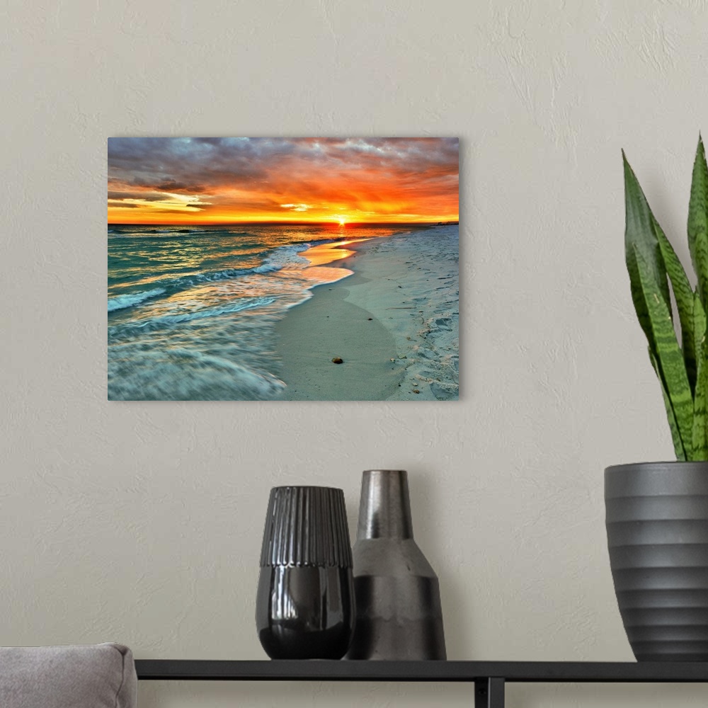 A modern room featuring Emerald waves flow over the shore in a soft white foam. Dark yellow and red sunset on the beach. ...