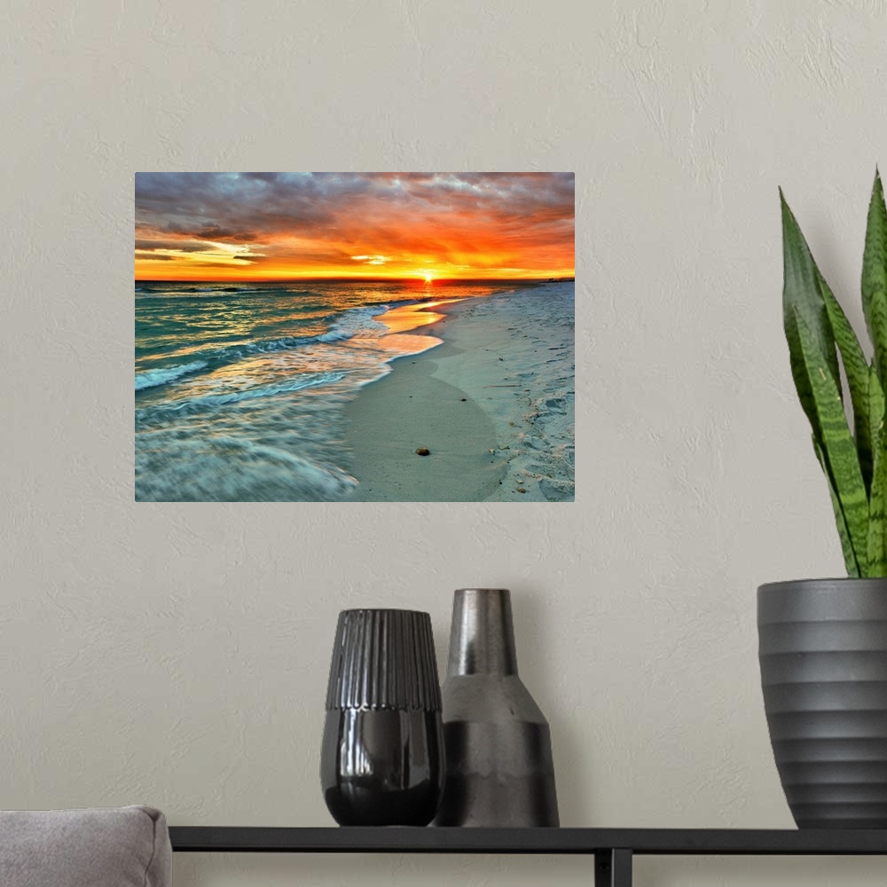 A modern room featuring Emerald waves flow over the shore in a soft white foam. Dark yellow and red sunset on the beach. ...