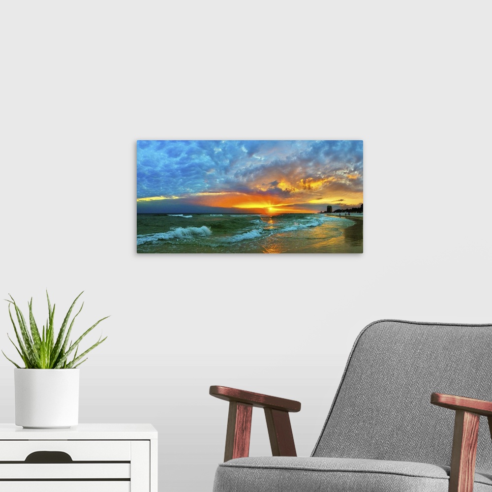 A modern room featuring Waves flow over the shore in a soft white foam. Dark yellow, blue, and orange skyscape. Landscape...
