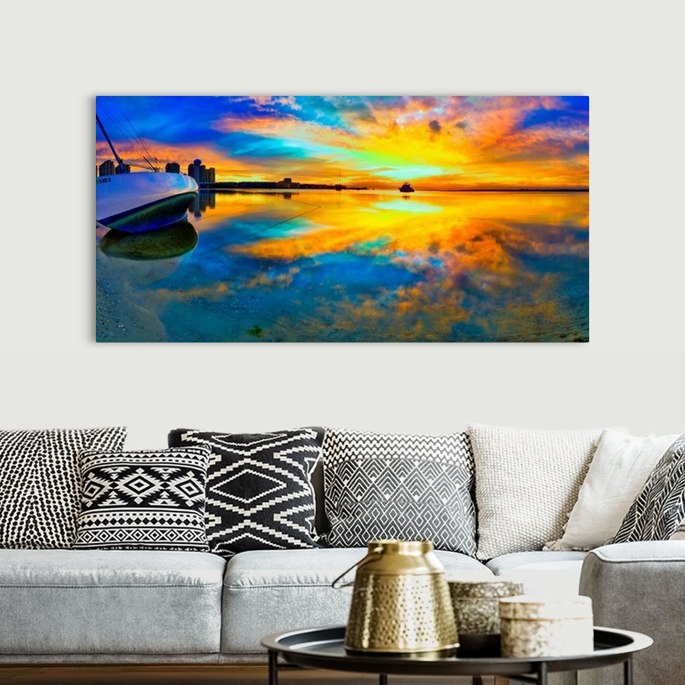 A bohemian room featuring A panoramic beach sunset with a burning bright reflection in the water. Yellow and blue sky refle...