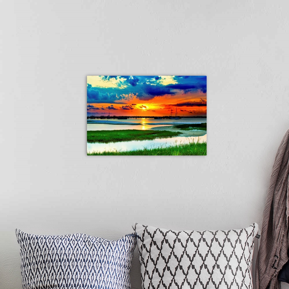 A bohemian room featuring Green grass panoramic. Red sunset over the lake and islands of green grass.
