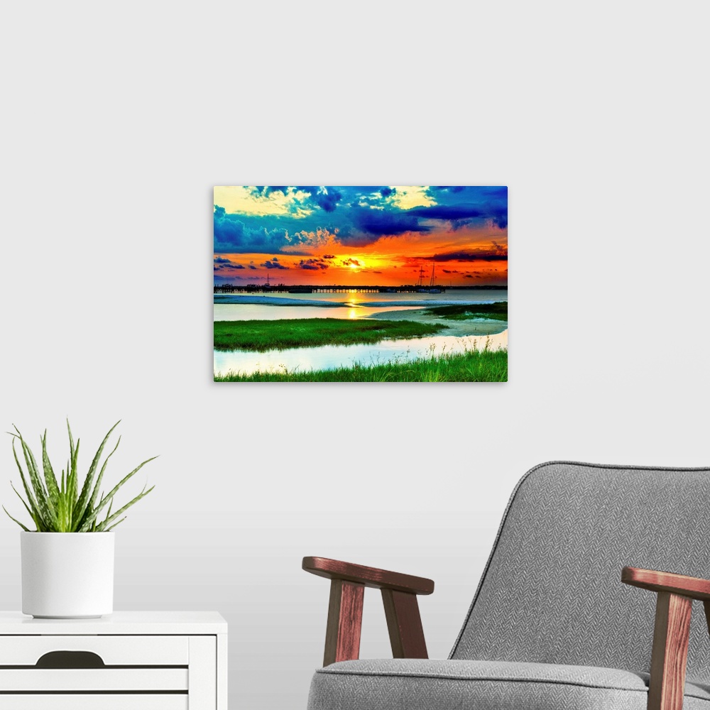 A modern room featuring Green grass panoramic. Red sunset over the lake and islands of green grass.