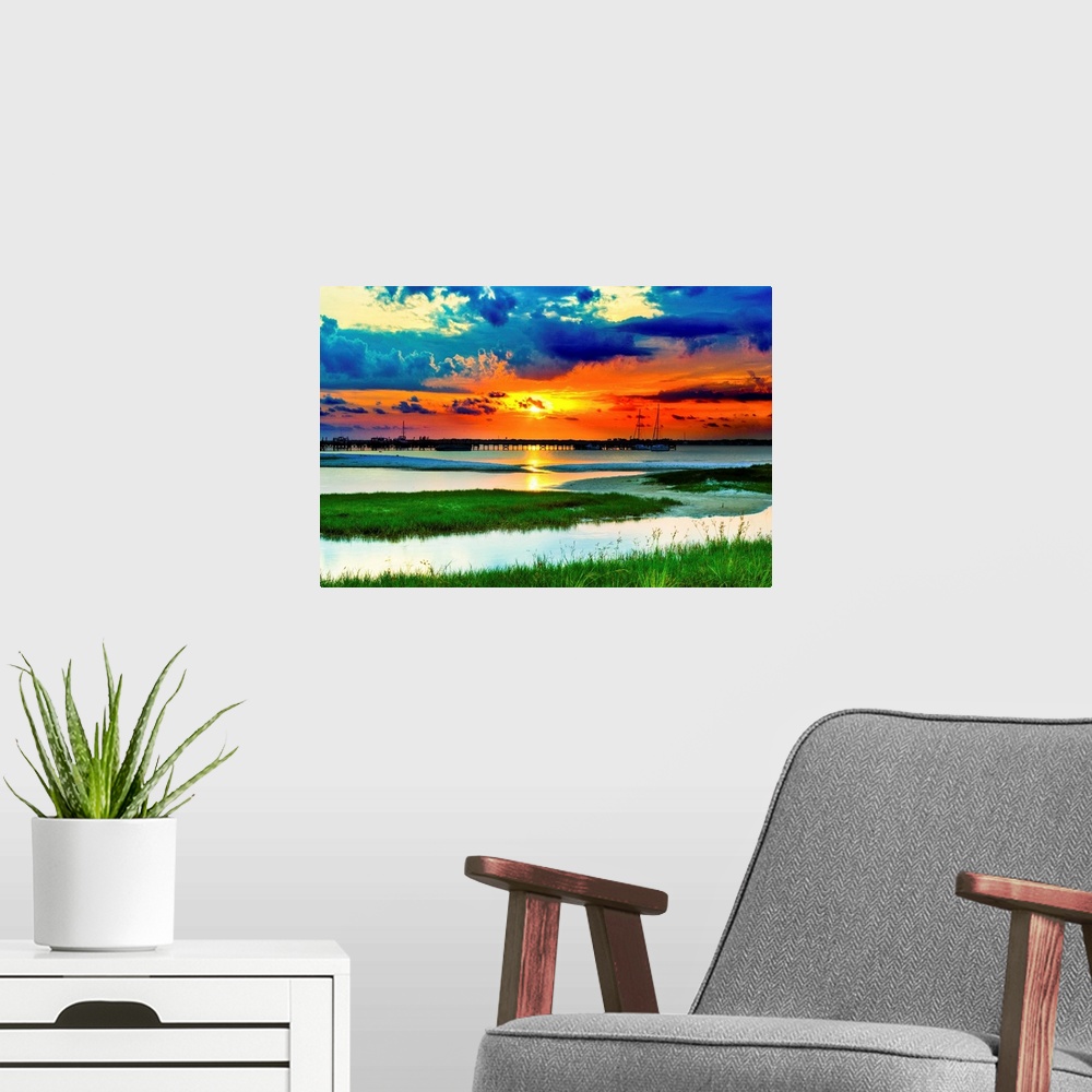 A modern room featuring Green grass panoramic. Red sunset over the lake and islands of green grass.