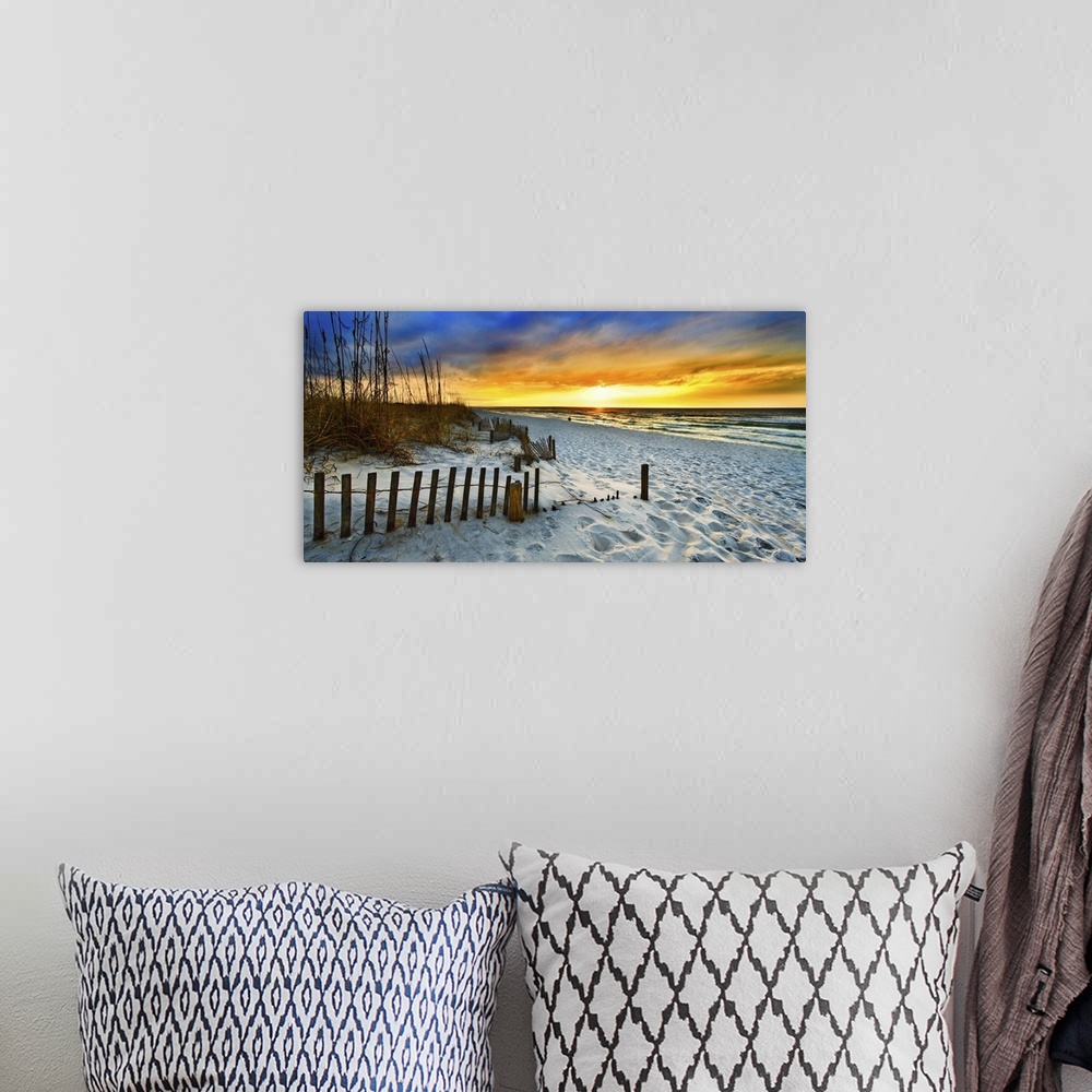 A bohemian room featuring White sandy shore in a panoramic landscape with a burning red sunset sky. Landscape taken on Nava...