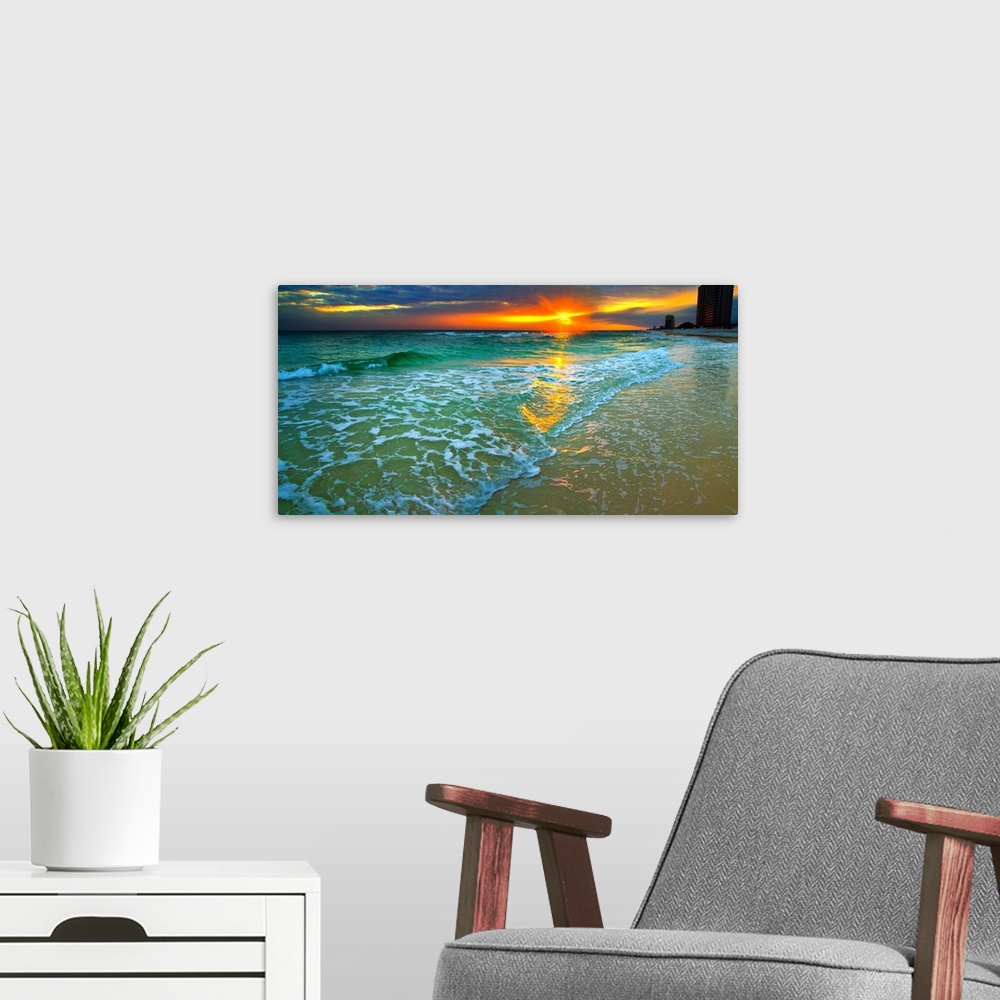 A modern room featuring Emerald waves and soft white foam. Dark yellow and red sunset seascape. Landscape taken on Navarr...