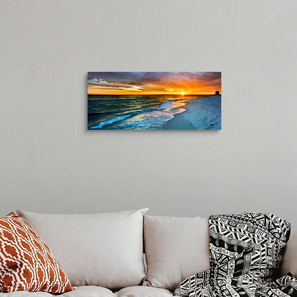 A bohemian room featuring A dark beach before a panoramic orange sunset with a burning red sky. Landscape taken on Navarre ...