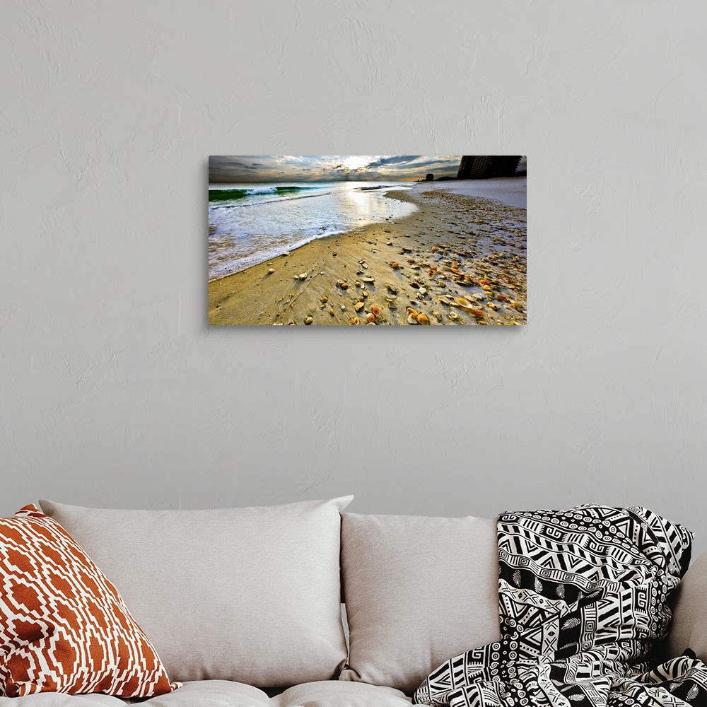 A bohemian room featuring Beach shells in this panoramic sunset with a calm blue seascape and sky. Landscape taken on Navar...