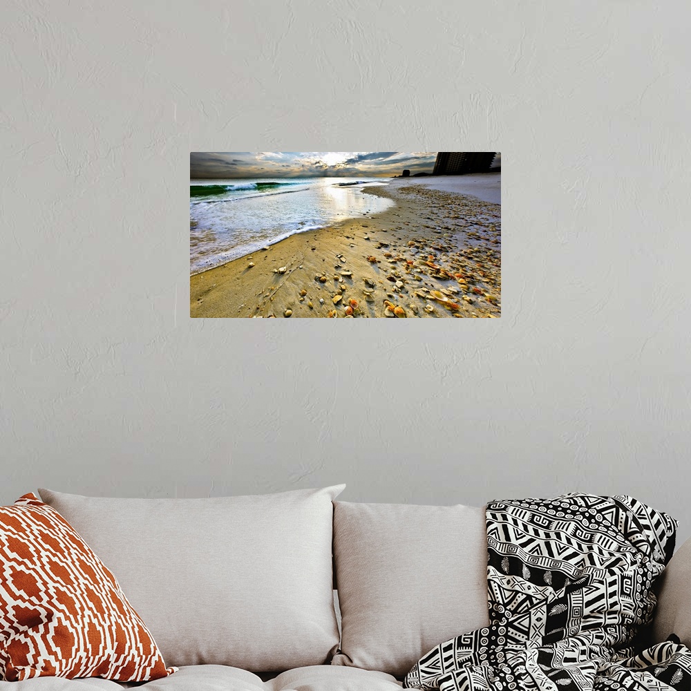 A bohemian room featuring Beach shells in this panoramic sunset with a calm blue seascape and sky. Landscape taken on Navar...