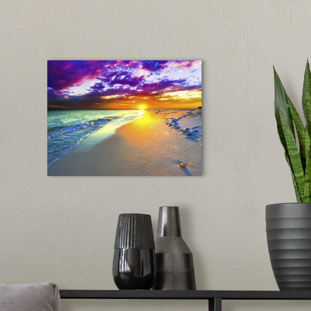A modern room featuring A beautiful purple and blue sunset over a sandy beach shoreline. The ocean takes up a small part ...