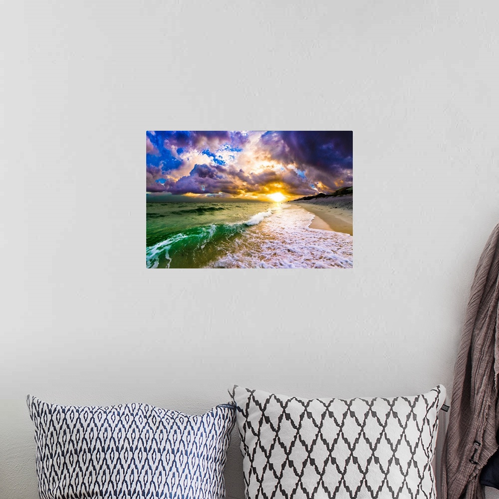 A bohemian room featuring A purple and blue sunset above a crashing wave hitting the shore.