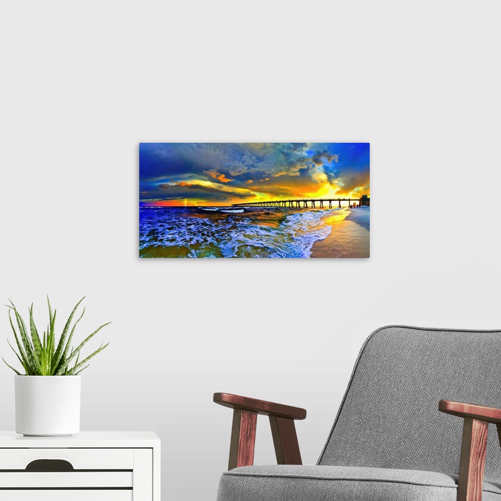 A modern room featuring Soft foamy waves flow before a dark yellow and blue sunset with a brilliant sunset rainbow. Lands...