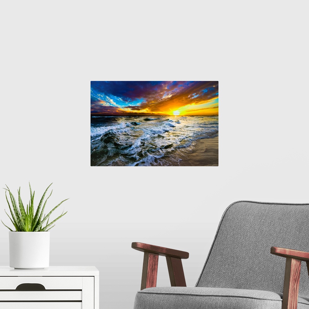 A modern room featuring A red and blue sunset on the beach with a turbulent ocean with waves. Strong dark to light contra...