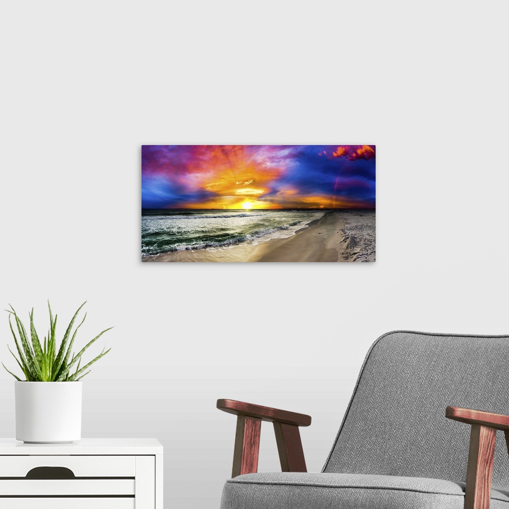 A modern room featuring A dark rainbow sunset with a beautiful blue, purple and red sky. This is a large beach panorama.