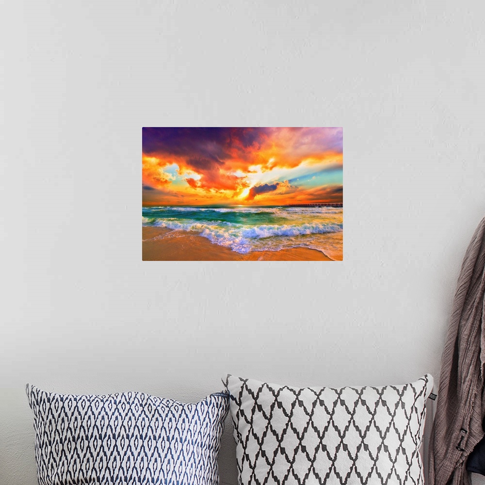 A bohemian room featuring A red, orange and purple sunset on the beach. Beautiful ocean waves roll onto the sea shore.