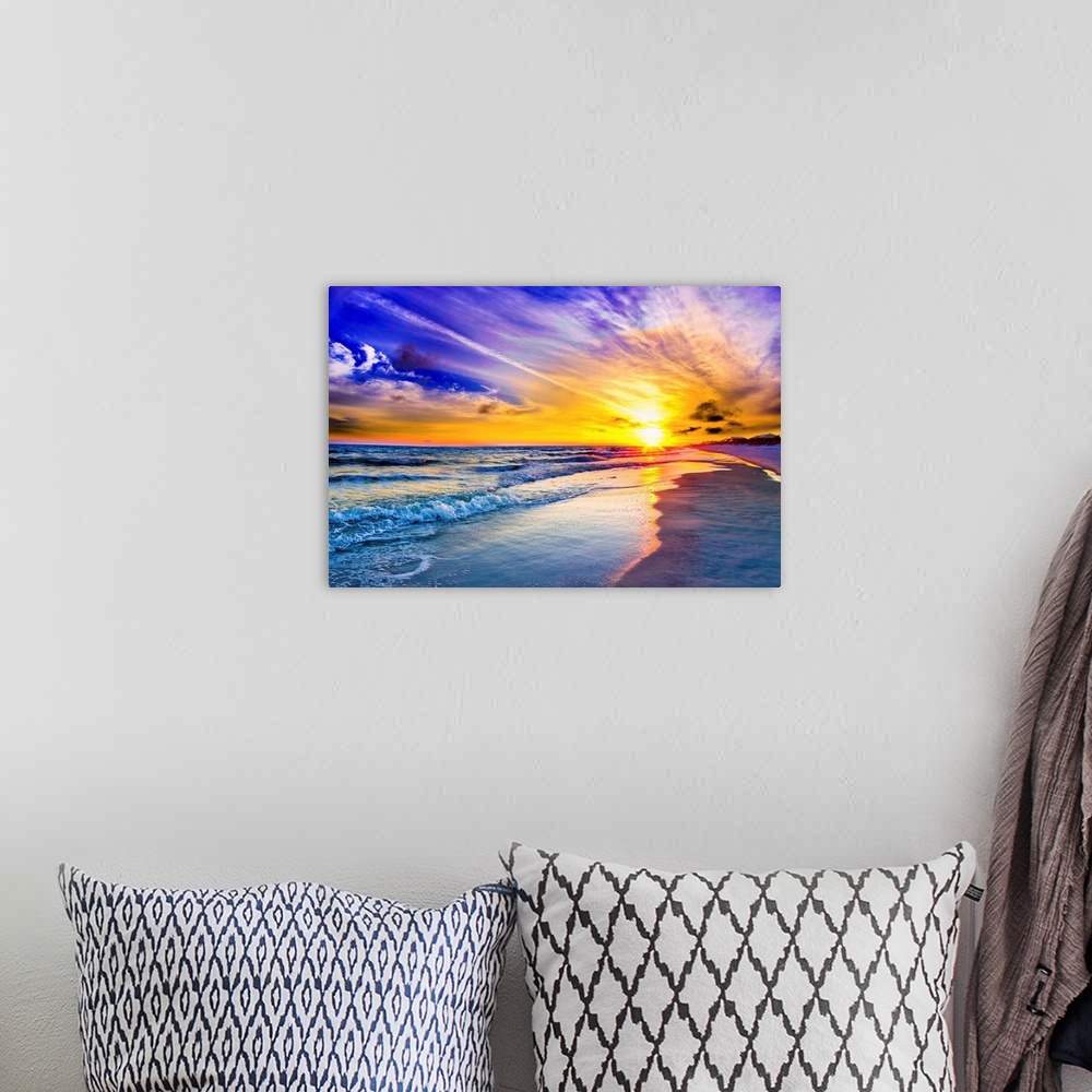 A bohemian room featuring An amazing sunset with pink and purple sky and clouds. A blue seascape and beach below.