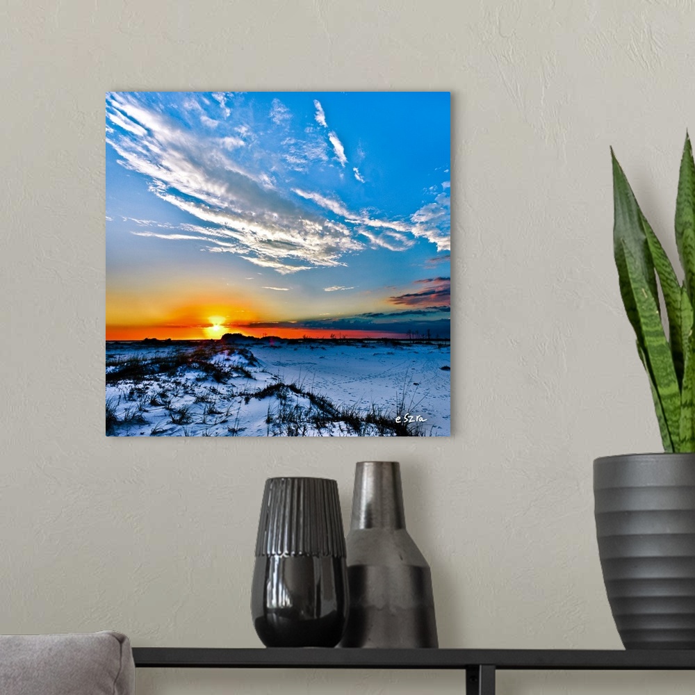 A modern room featuring Blue hills under a desert sunset with a lonely white cloud.