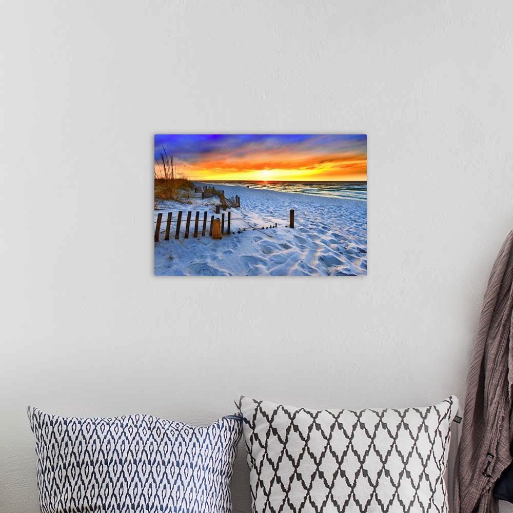 A bohemian room featuring A dark burning red sunset on the beach in this beautiful landscape. A burning sun sets in the dis...