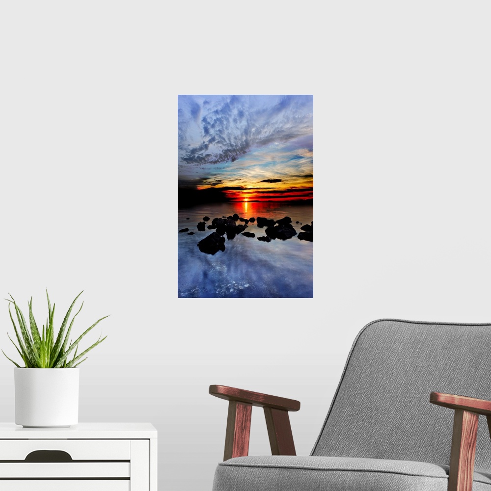 A modern room featuring Blue clouds reflected in the sea in the red sunset landscape.