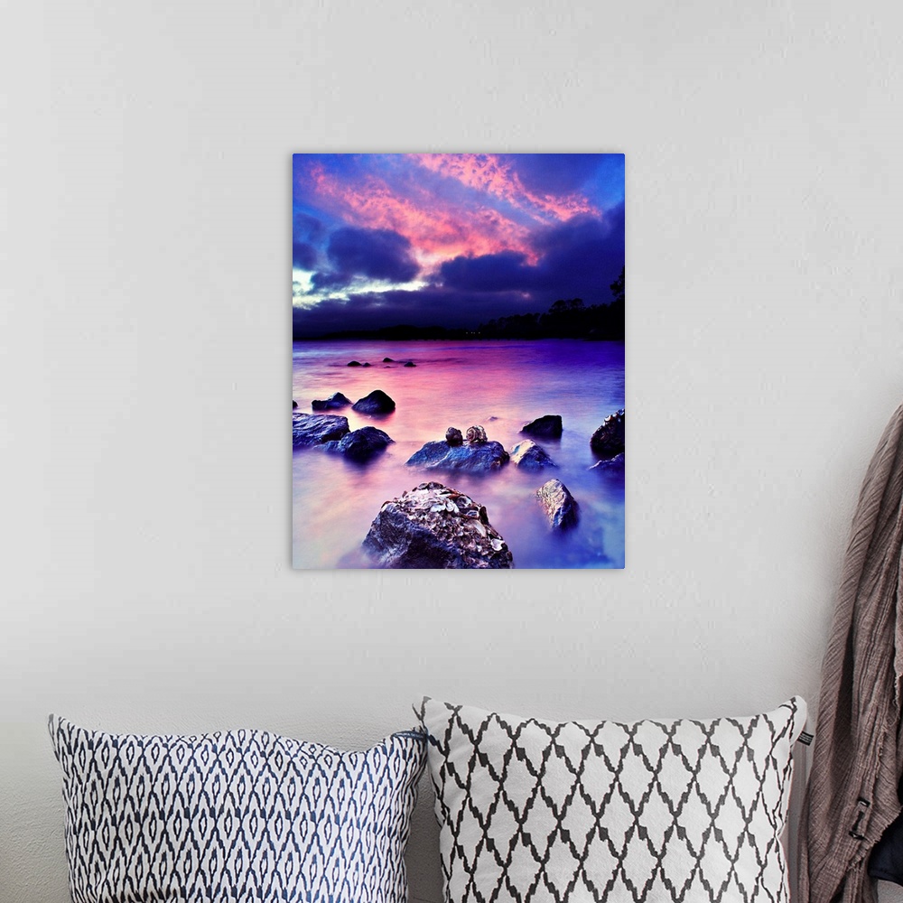 A bohemian room featuring A romantic art print for valentines under a pink and blue sky.
