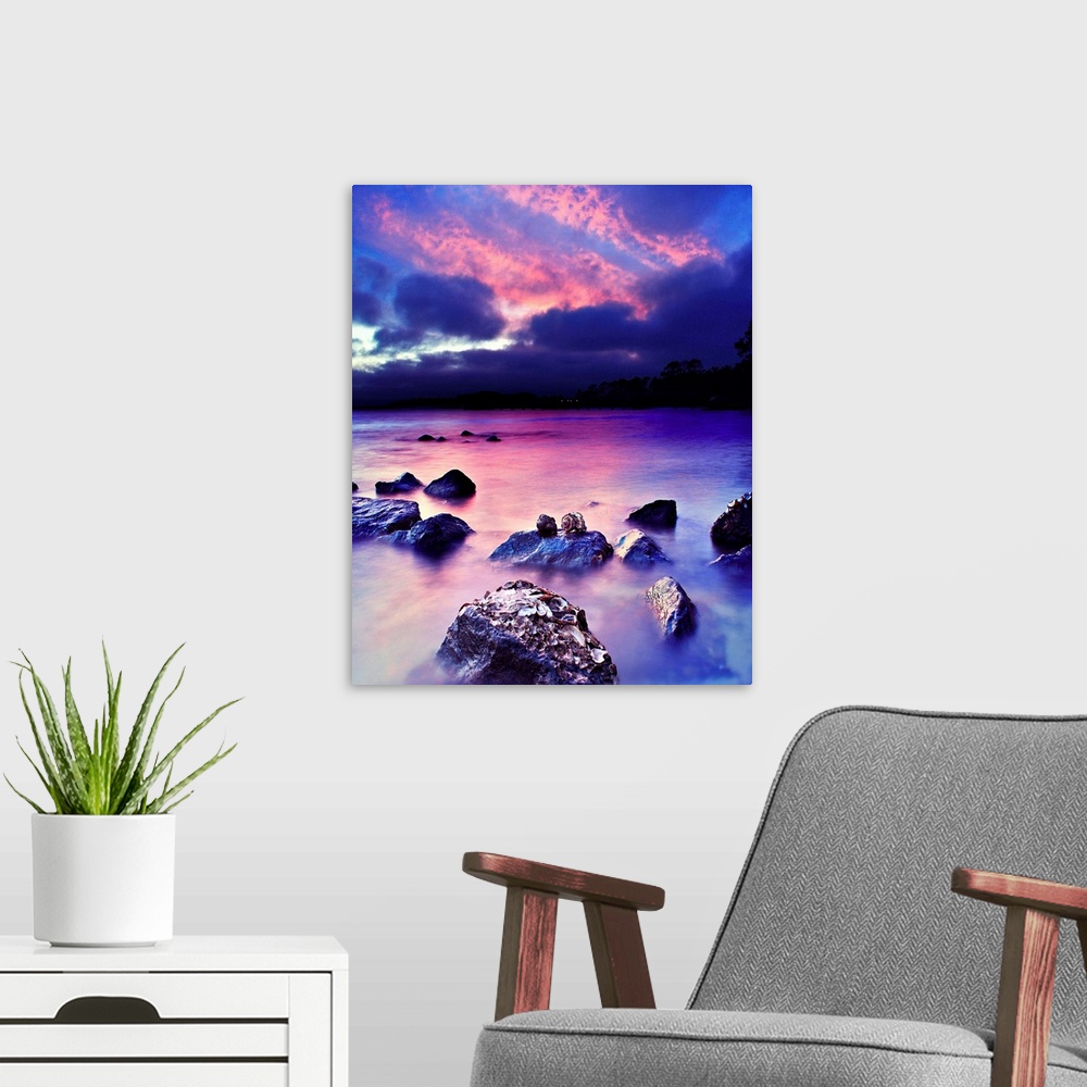 A modern room featuring A romantic art print for valentines under a pink and blue sky.
