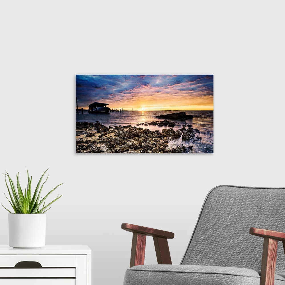 A modern room featuring Barnacle covered shore shipwreck at sunrise on the beach.