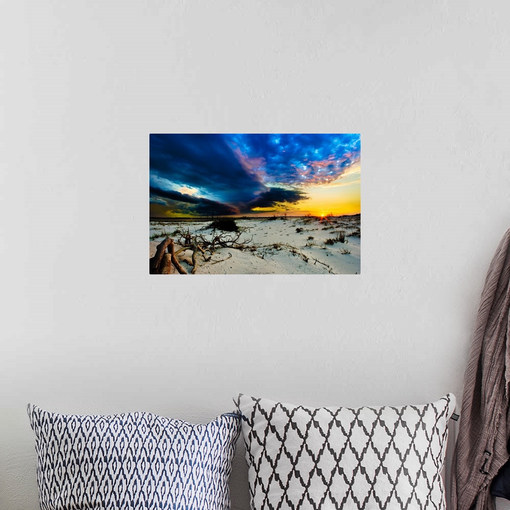 A bohemian room featuring Blue storm clouds encroaching on a sunset.