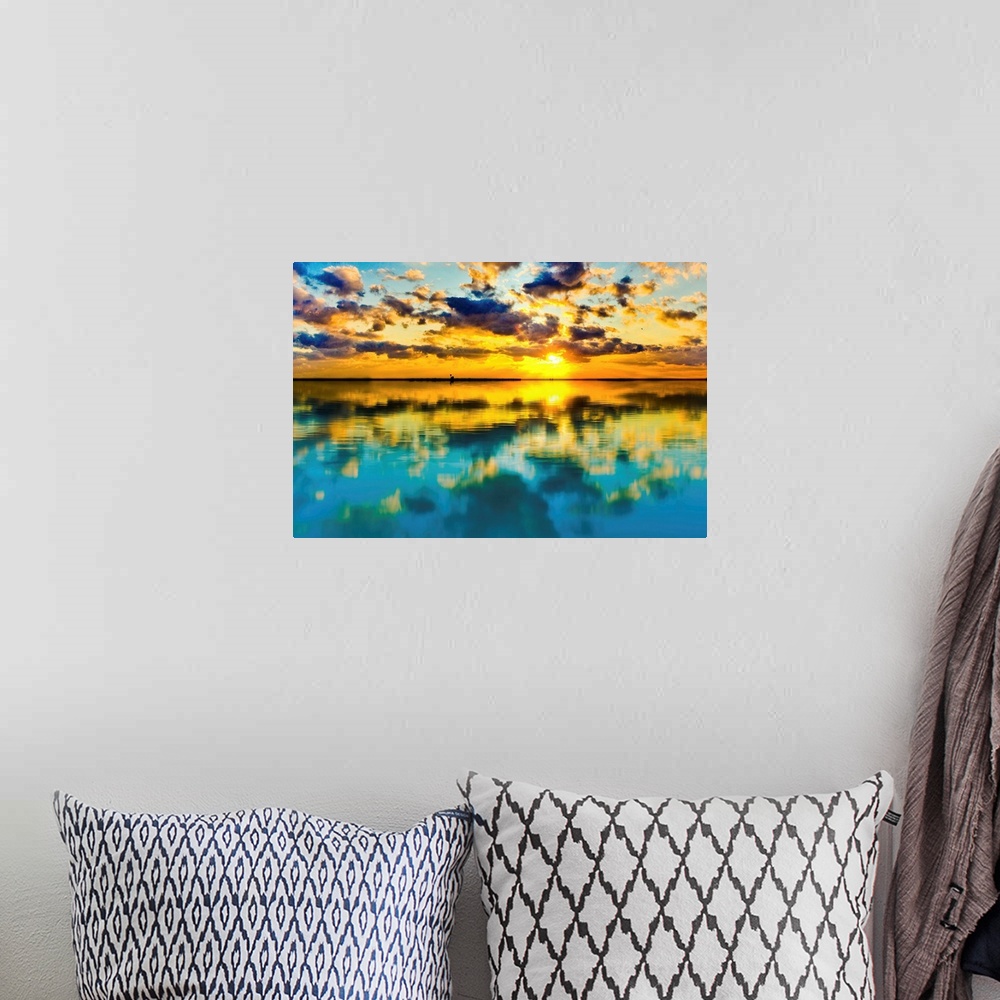 A bohemian room featuring A blue and yellow sunset lake reflection of a skyscape.