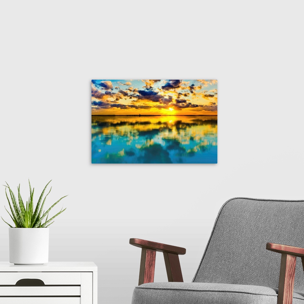 A modern room featuring A blue and yellow sunset lake reflection of a skyscape.