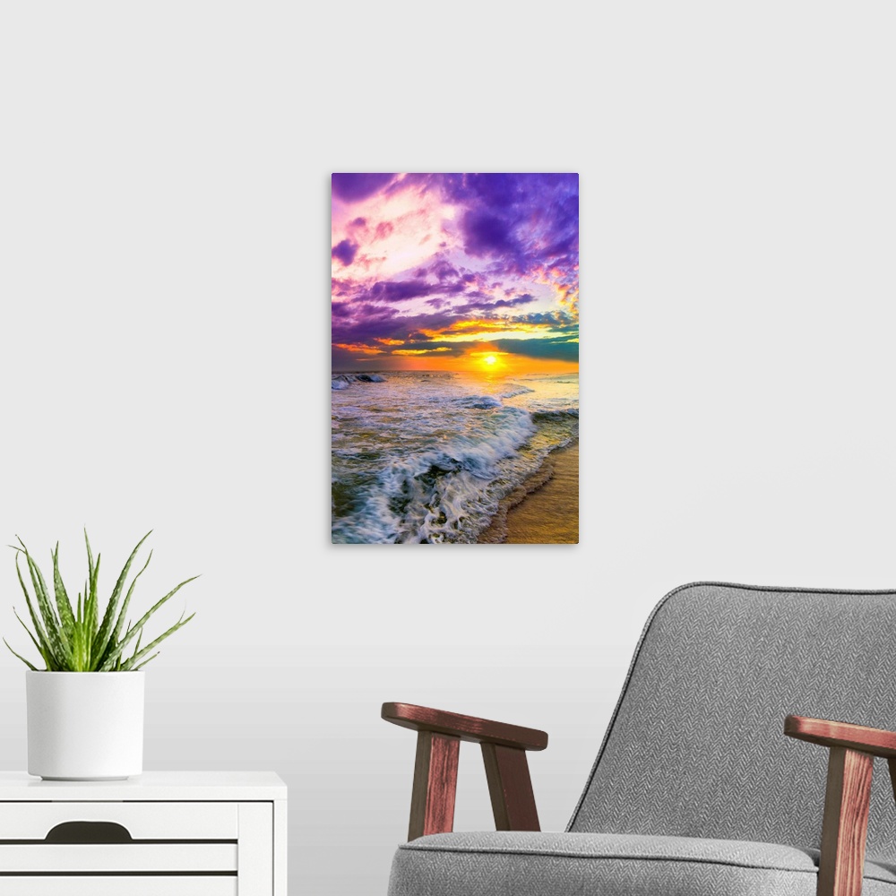 A modern room featuring A pink and purple beach sunset over the ocean. The expansive vertical sky is excellent for a vert...