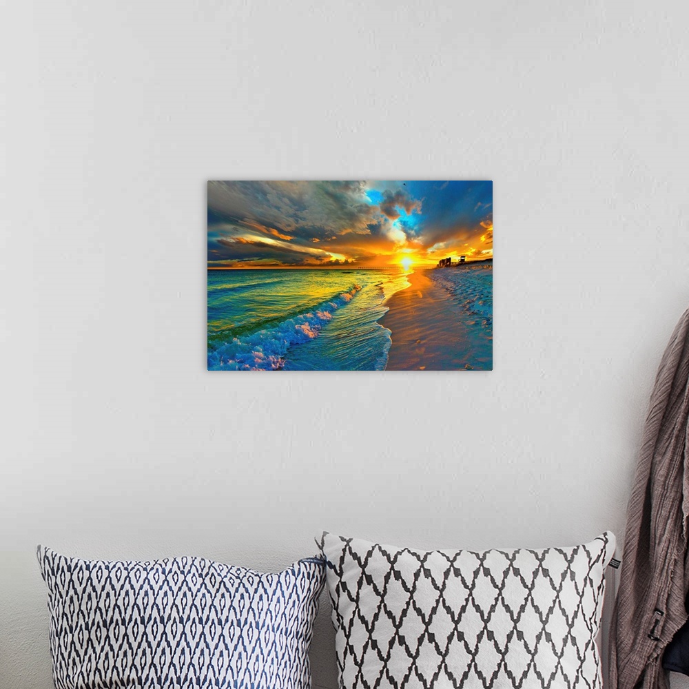 A bohemian room featuring Image of waves crashing before a dark yellow and blue sunset seascape over an emerald green seasc...