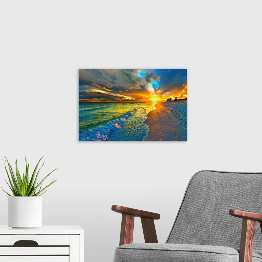 A modern room featuring Image of waves crashing before a dark yellow and blue sunset seascape over an emerald green seasc...