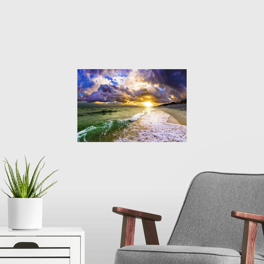 A modern room featuring A dark sunset featuring sun through breaking waves of white surf on beach.