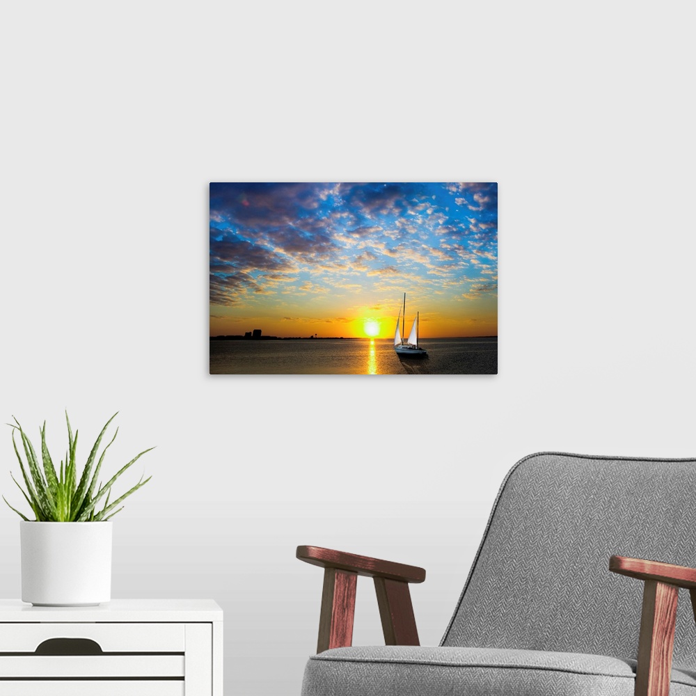 A modern room featuring A sailboat sailing into the sun under a blue sky.