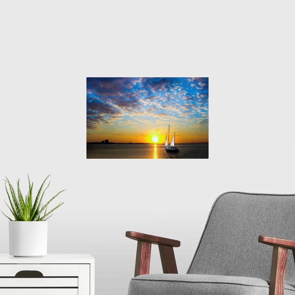 A modern room featuring A sailboat sailing into the sun under a blue sky.