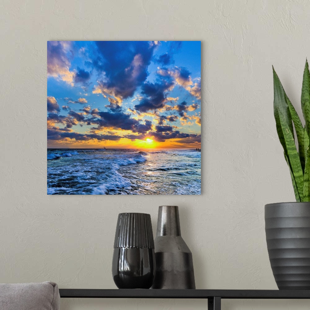A modern room featuring A Florida sunset with expanding puffy blue clouds during winter.